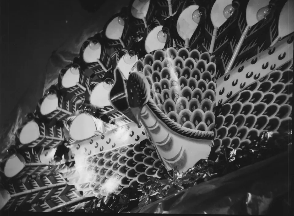 a black and white photo of a large peacock decoration display