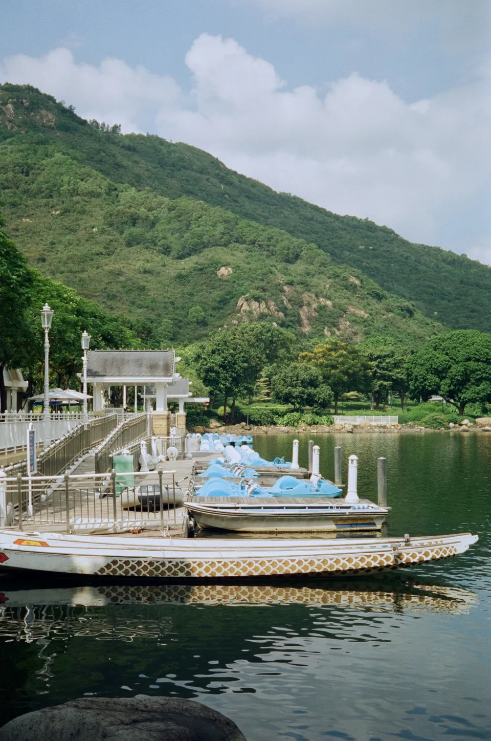 Paddle boats and dragon boat at the pier of the Inspiration Lake