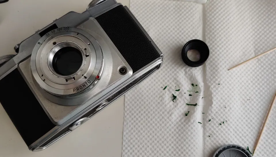 Memar with lens elements removed, green grease